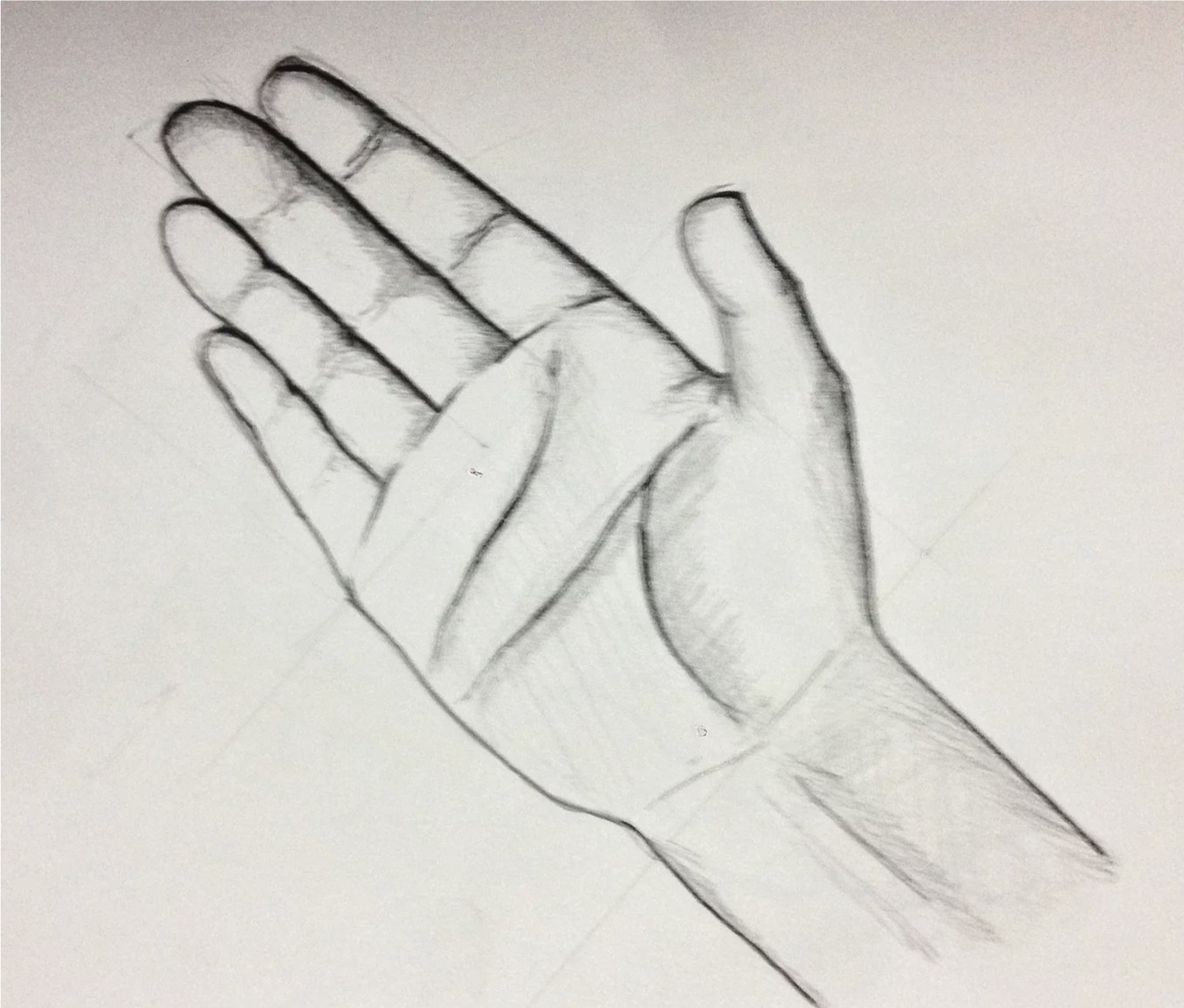 Fully shaded pencil study of a hand seen from an angled perspective