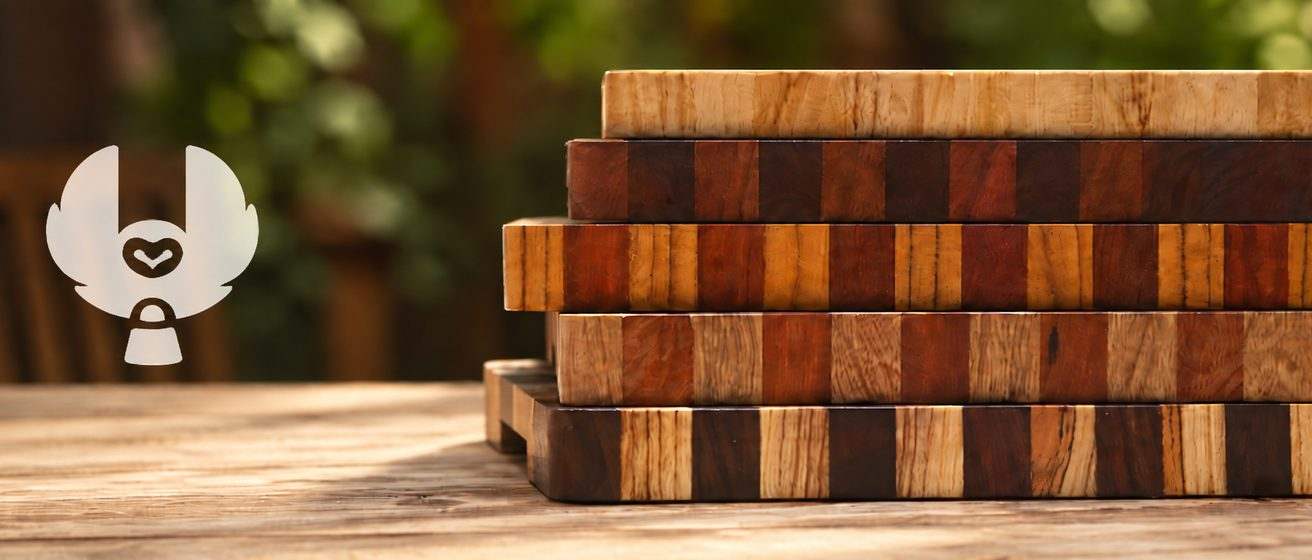 A stack of finished Búho GT end-grain butcher blocks on a wood table