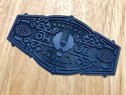 The laser-cut engraving die used for the logo stamp